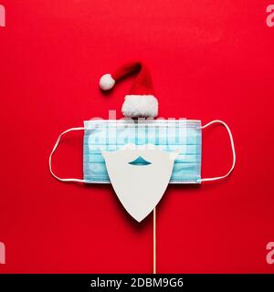 Festive christmas Santa Claus face made from face mask and decorations Stock Photo