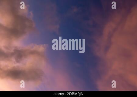 A sky in beautiful colors at sunset with a few clouds Stock Photo