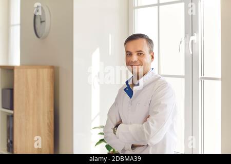 Portrait of young positive man office worker manager in white official shirt Stock Photo