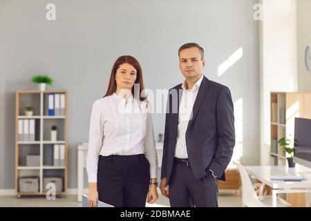 Portrait of confident business people standing in the office and looking at camera Stock Photo