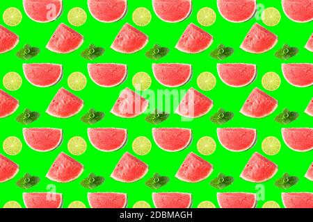 Creative layout of seamless fruits pattern photo. watermelon slices, mint leaves and lemon on neon green color background. Collage art. Healthy vitami Stock Photo