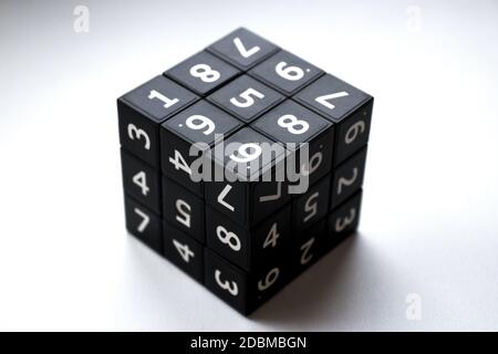 Black cube with numbers in its area for playing the Japanese Sudoku game on a white background Stock Photo