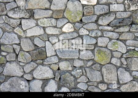 Big wall made from curved grey stones Stock Photo