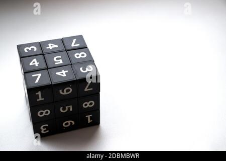 Black cube with numbers in its area for playing the Japanese Sudoku game on a white background Stock Photo