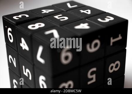 Black cube with numbers in its area for playing the Japanese Sudoku game on a white background Stock Photo