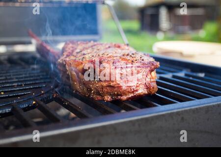 Dry Aged Barbecue Tomahawk Steak on grill Stock Photo