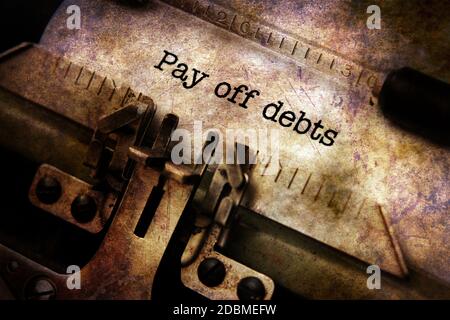 Pay off debts text on typewriter Stock Photo