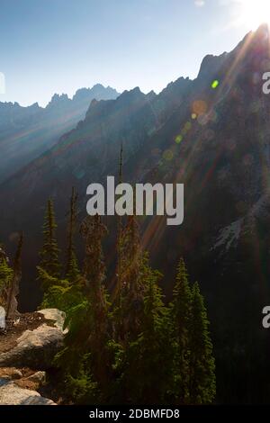 WA18160-00...WASHINGTON - The sun rising over a rugged ridge viewed from the Washington Pass Overlook in the Okanogan - Wenatchee National Forest. Stock Photo