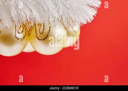 Christmas golden toys for greeting card on the red background Stock Photo