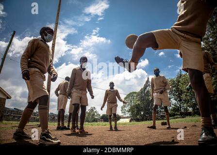 Nairobi, Kenya. 13th Jan, 2019. School boys playing while wearing face masks as a precaution at Ayany Primary School.After a long period of closure due to the coronavirus pandemic schools reopened under precautionary measures such as social distancing between pupils in classes, having student's temperatures checked regularly and washing hands with sanitiser. Credit: Donwilson Odhiambo/SOPA Images/ZUMA Wire/Alamy Live News Stock Photo