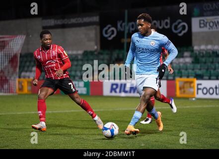 Lincoln City’s Tayo Edun and Manchester City's Jayden Braaf (right) battle for the ball during the Papa John's Trophy match at Sincil Bank, Lincoln. Stock Photo