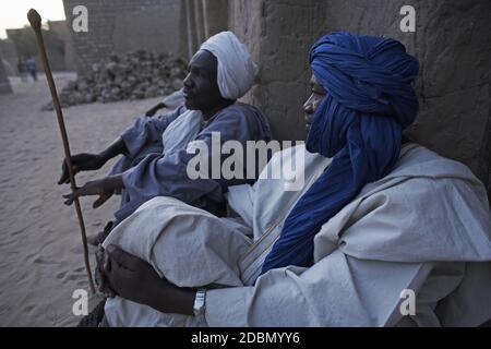 Two muslim man waiting in front of the Sankore mosque, in Timbuktu, Mali. Stock Photo