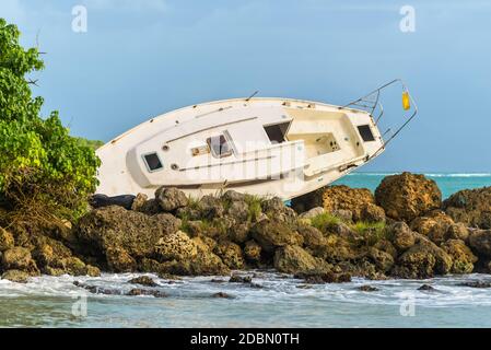 Sailboat was destroyed and abandoned on the shore after a hurricane - the Gosier in Guadeloupe, Caribbean Stock Photo