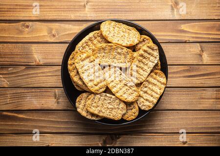 Rusk bread. Dried crispbread on plate. Top view. Stock Photo