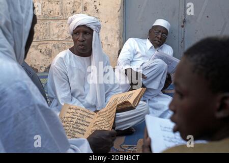 Local men reading from Manuscript Poetry in Timbuktu, Mali, Stock Photo