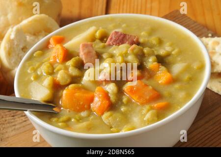 A bowl of split pea soup with ham Stock Photo