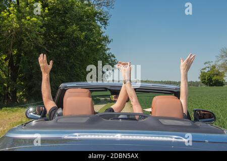 Smiling happy senior couple in a luxury convertible car Stock Photo