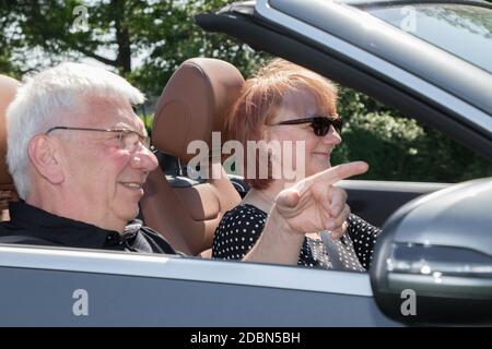 Happy senior couple in sports car on a sunny day Stock Photo