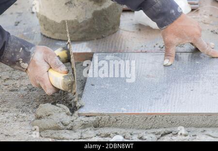 Mason was repaired for the floor tile Stock Photo