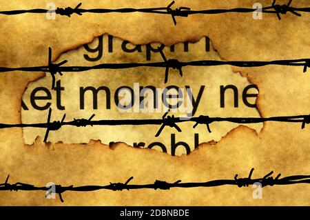 Money paper hole against barbwire Stock Photo