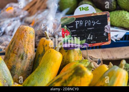 Fort-de-France, Martinique - December 19, 2016: Papaya with price in the fruit and vegetable market of Fort de France in Martinique, Lesser Antilles, Stock Photo