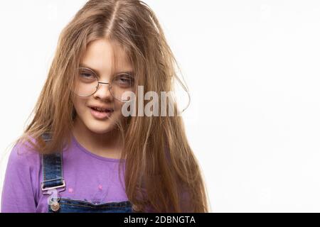 Portrait of a sleepy yawning girl of eleven on a white background Stock Photo