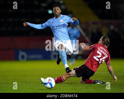 Lincoln City’s Harry Anderson (right) and Manchester City's Keyendrah Simmonds (left) battle for the ball during the Papa John's Trophy match at Sincil Bank, Lincoln. Stock Photo
