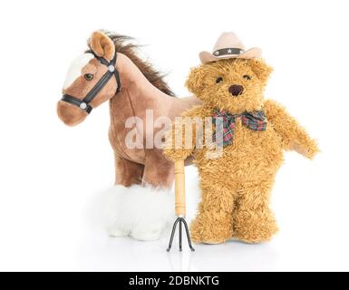 Teddy bear  farmer with pitchfork  and horse on white background Stock Photo