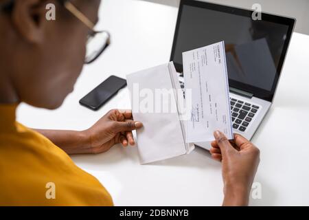 American African Holding Paycheck Or Payroll Check Stock Photo
