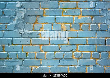 Blue old painted bricks wall texture with yellow Stock Photo