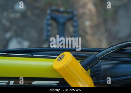 Yellow plastic lock fixed on a bicycle close up Stock Photo