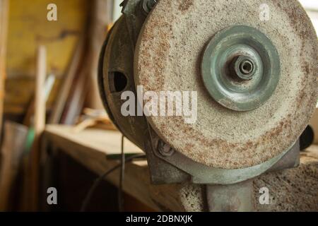 Old rusty Grindstone grinder in the workshop Stock Photo