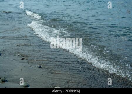 Stone beach with waves. Multi colore stones on beach Stock Photo