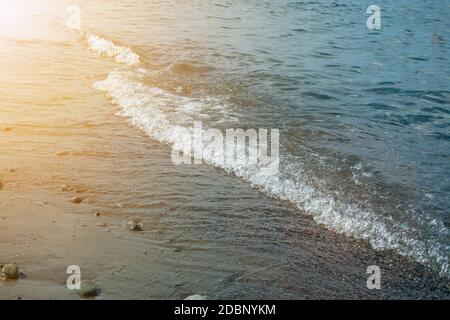 Stone beach with waves. Multi colore stones on beach Stock Photo