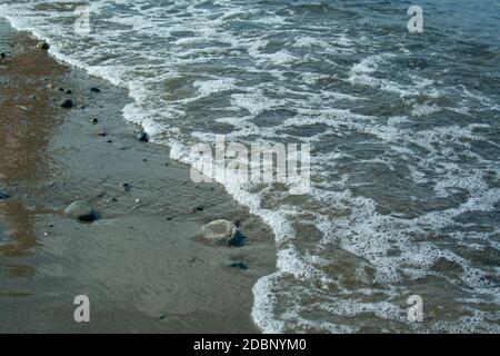 Stone beach with waves. Multi colore stones on beach Stock Photo