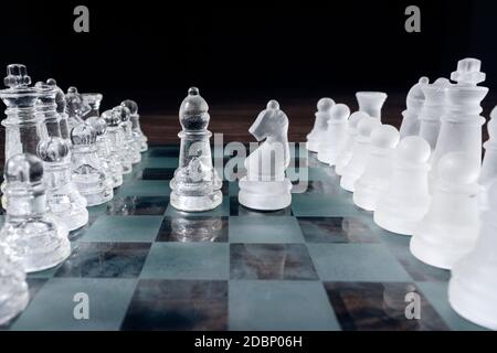 Pieces of chess on a chess board. Knight and bishop face to face Stock Photo