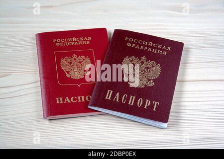 Two russian passports close up on wooden background. Civil and foreign passports Stock Photo