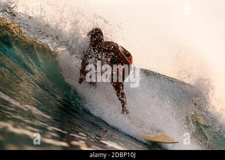 Surfer riding wave, Gerupuk,Ã‚Â Lombok, Indonesia Stock Photo