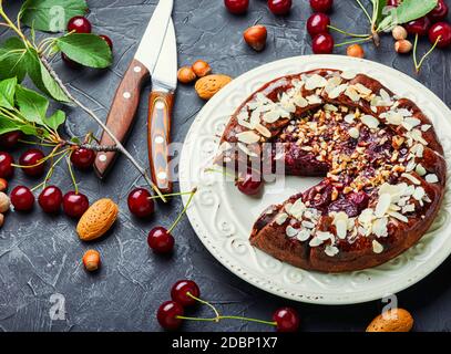 Yummy American homemade cherry pie on the table.Cherry galette.Cherry chocolate cake. Stock Photo