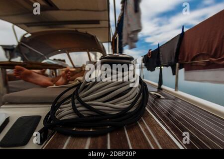Sail winch with rope and sleeping man on yacht, Lombok, Indonesia Stock Photo