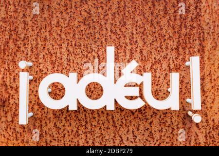 Goodbye word written in catalan on a metal plate. Stock Photo