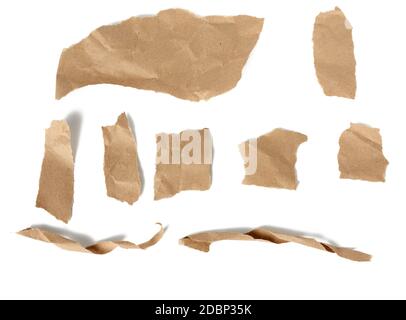 various pieces and twisted brown paper strips and torn pieces isolated on white background, top view Stock Photo