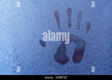 Hand print on icy window. Close up of hand print Stock Photo
