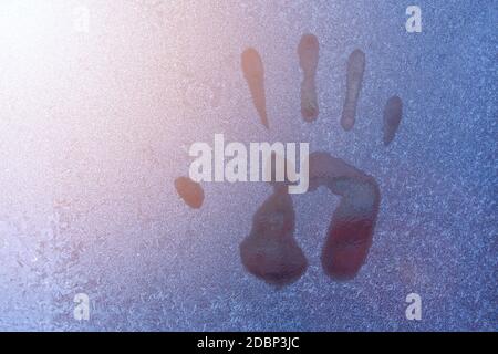 Hand print on icy window. Close up of hand print Stock Photo