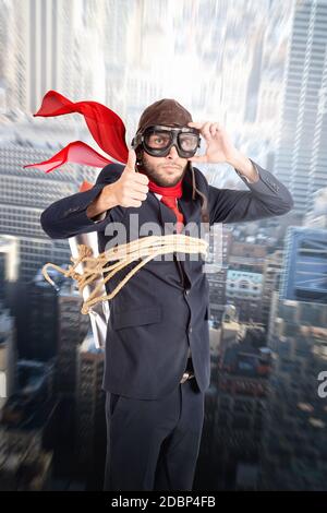 Businessman with homemade rocket and googles ready to take off! Stock Photo