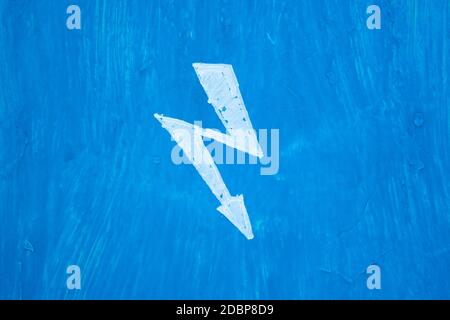 White sign danger electricity on steel blue painted wall in switchboard. Texture with paint stains and rusty Stock Photo