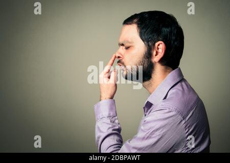 man with beard touching his nose Stock Photo