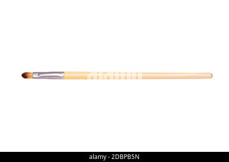 Closeup of a wooden new professional makeup brush isolated on a white background. Concept beauty. Macro photograph. Stock Photo