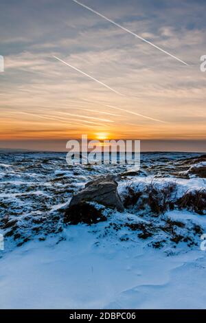 Sunset over a cold, frozen winter landscape on high moorland Stock Photo