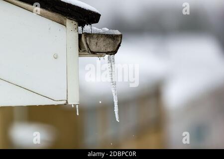 Icicles on the gutter of a house on a cold, frozen winters day Stock Photo